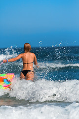 Image showing Woman running in the sea 