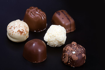 Image showing Delicious chocolates on black background 