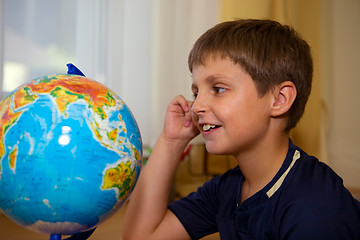 Image showing boy looking globe of world 