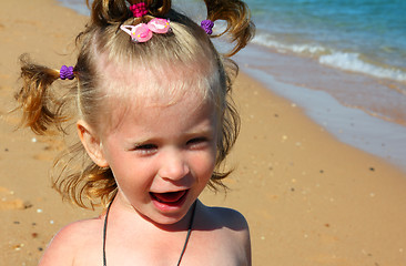 Image showing happy little girl on sand beach