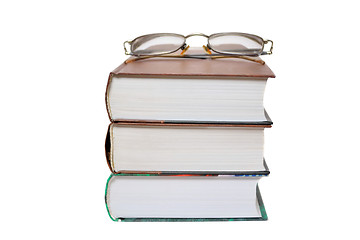 Image showing Eyeglasses on the books isolated on white