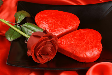 Image showing Two red heart shaped cakes and a rose