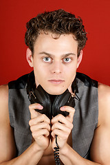 Image showing Young attractive disc jockey wearing headphones