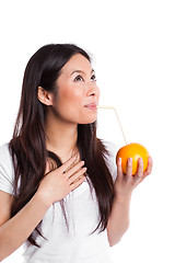 Image showing Asian woman drinking orange juice