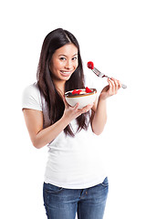 Image showing Asian woman eating fruit