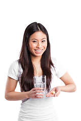 Image showing Asian woman taking vitamins