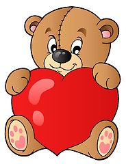 Image showing Cute teddy bear holding heart