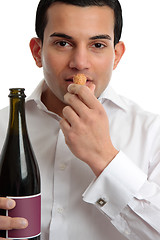 Image showing Man or wine steward sniffing wine cork