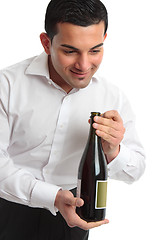 Image showing Waiter presenting bottle of wine