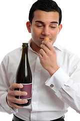 Image showing Man sniffing wine cork