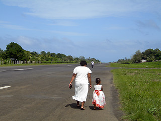 Image showing mother daughter walking of airport runway Corn Island Nicaragua