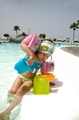 Image showing Child playing by pool