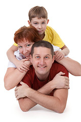 Image showing Mom and Dad and son lying on a white background