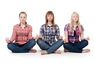 Image showing Three girls sitting in lotus posture