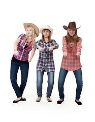 Image showing Three girls in hats