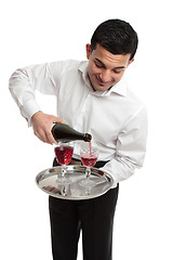 Image showing Waiter or servant pouring wine