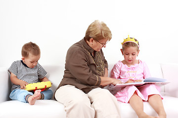 Image showing Reading and playing with granny