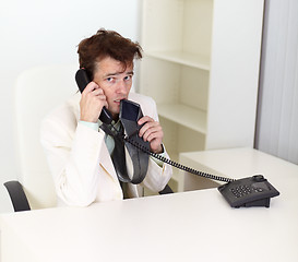 Image showing Disheveled businessman talking on phone very excited