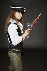 Image showing Young beautiful girl - sea pirate with pistol