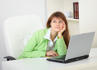 Image showing Girl dreams working with laptop at office