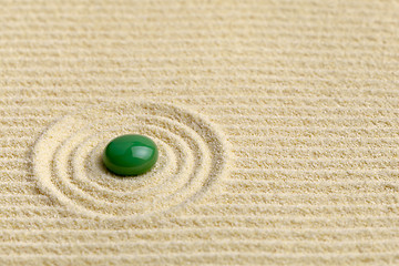 Image showing Artistic composition with green drop on surface of yellow sand