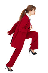 Image showing Young woman in business suit is moving forward