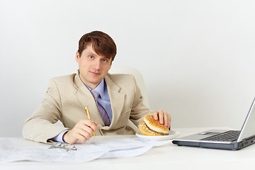 Image showing Businessman is going to eat delicious sandwich without interrupt