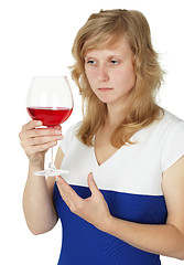 Image showing Woman holding glass of red wine on white