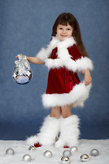 Image showing Little girl in Christmas costume with glass ball