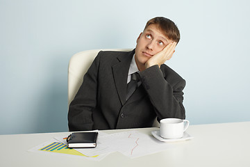 Image showing Businessman pensively looks upwards