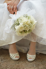 Image showing Bouquet of bride against dress and shoes