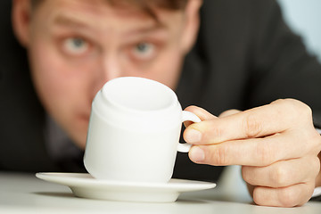 Image showing Businessman makes predictions using coffee grounds