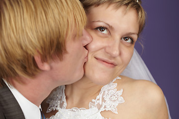 Image showing Groom kisses bride