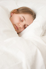 Image showing young woman asleep in bed