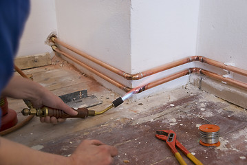 Image showing plumber soldering