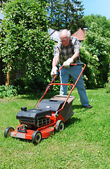 Image showing man with lawn mower