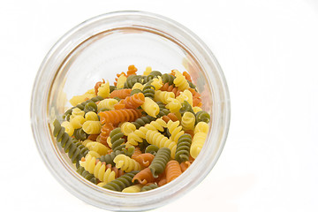 Image showing Colorful raw fusilli in a jar