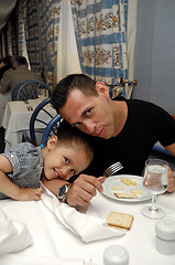 Image showing Father and daughter at dinner table