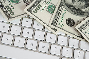 Image showing Hundred dollar bills on computer keyboard