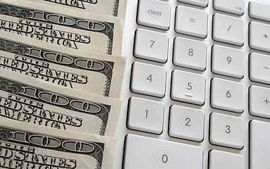 Image showing American dollars near computer keyboard calculator