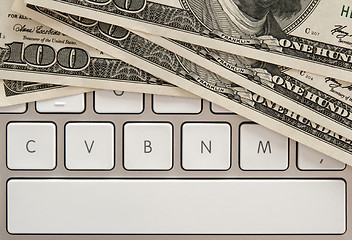 Image showing Money bills on computer keyboard with spacebar