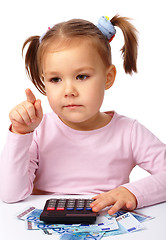 Image showing Little girl plays with money