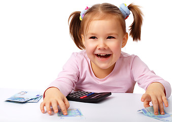 Image showing Little girl with few paper euro banknotes