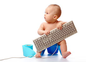 Image showing Little child is typing on keyboard