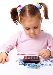 Image showing Little girl plays with money