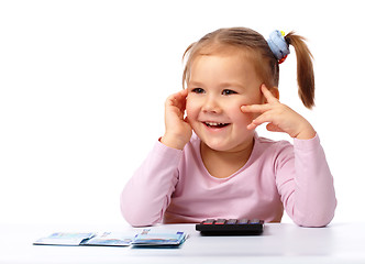 Image showing Little girl with few paper euro banknotes