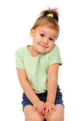 Image showing Cute little girl is sitting on floor and smile