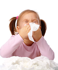 Image showing Little girl blows her nose