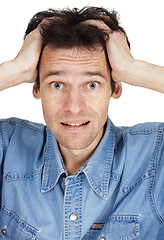 Image showing Confused young man has clasped hands a head