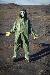 Image showing Man in chemical protective suit in desert